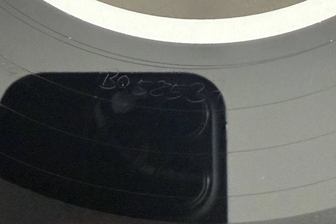Etched runout characters visible beside a record label